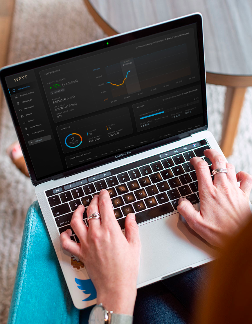 Person on Macbook Pro laptop Checking We Fund You Trade dashboard